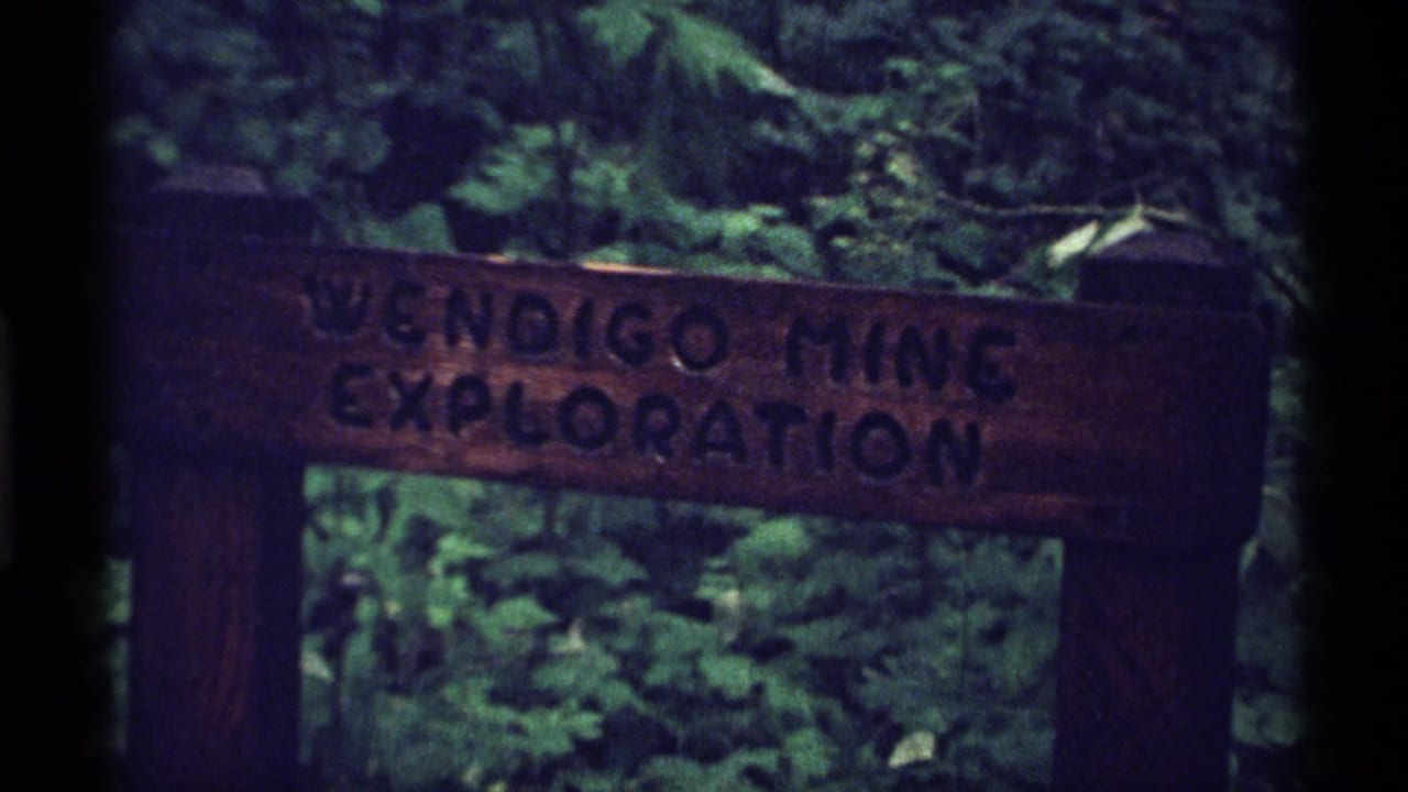 Wooden Wendigo Mine Exploration sign in a dark green forest.
