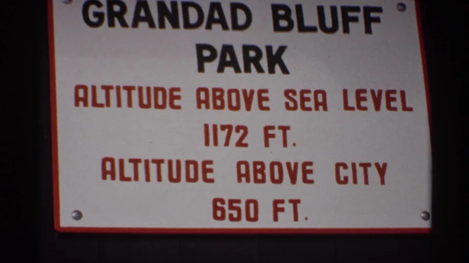 Close 8mm frame of the Grandad Bluff Park sign in La Crosse, Wisconsin, with altitude details visible.