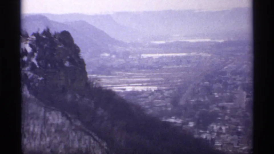 Home-movie vista from Grandad Bluff Park looking across La Crosse and the surrounding valley in soft 8mm color.