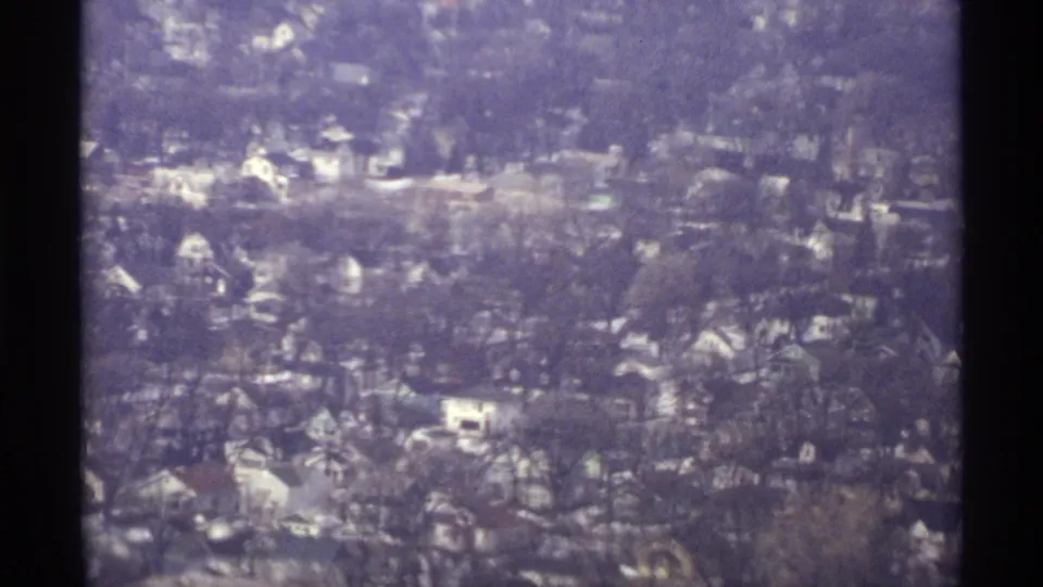 Vintage aerial view over a dense La Crosse neighborhood, with varied rooflines, bare tree canopies, and residential blocks below.
