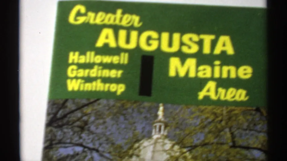 1971 8mm close-up of a Greater Augusta, Maine brochure, with town names and the capitol photograph partly visible.