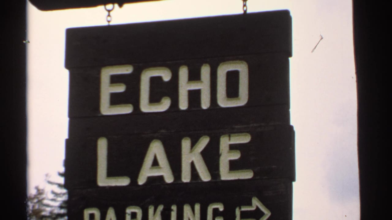 Wooden Echo Lake Parking sign with a directional arrow at the frame edge.