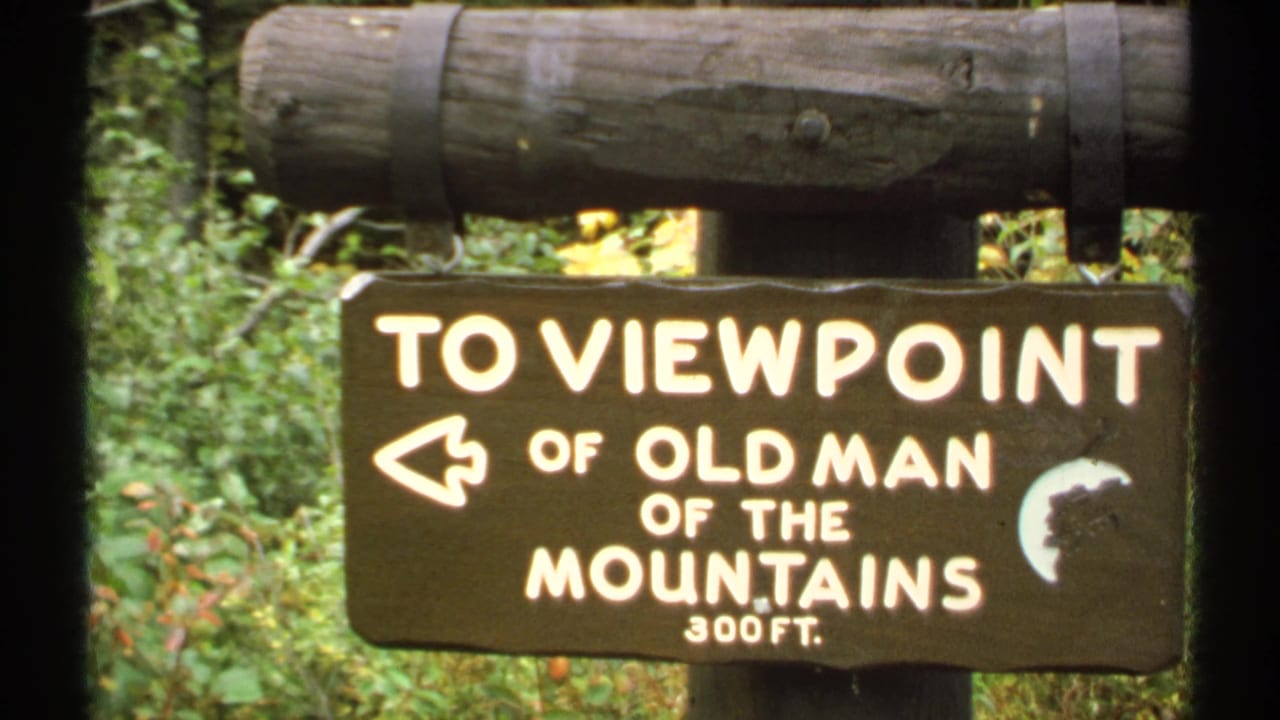 Rustic sign points left toward the Old Man of the Mountains viewpoint, 300 feet away.
