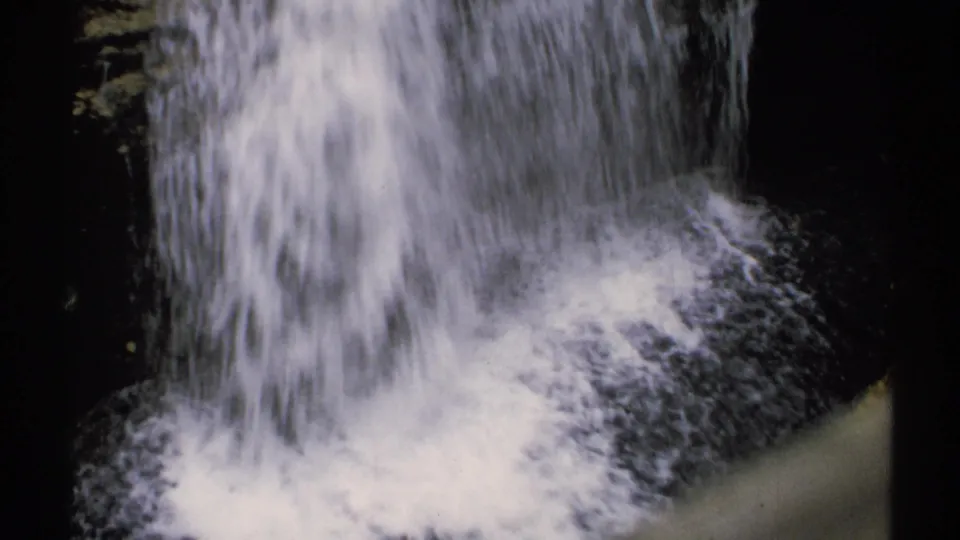 1971 New Hampshire waterfall close-up showing white foam and spray at the base of the fall.