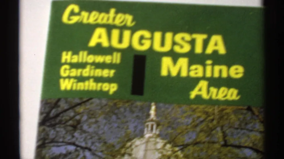 Tighter 1971 8mm view of the brochure cover text for Greater Augusta, Maine Area, with the capitol photograph partly visible below.