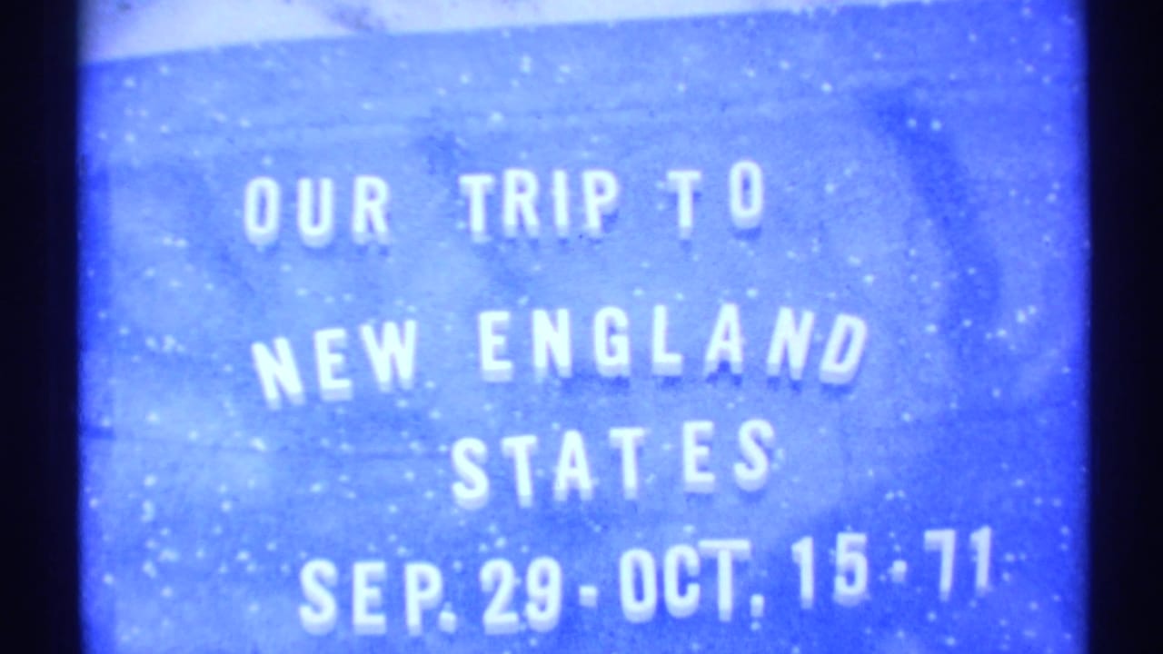 1971 8mm home-movie title card reading “Our Trip to New England States” with dates below on a blue background.