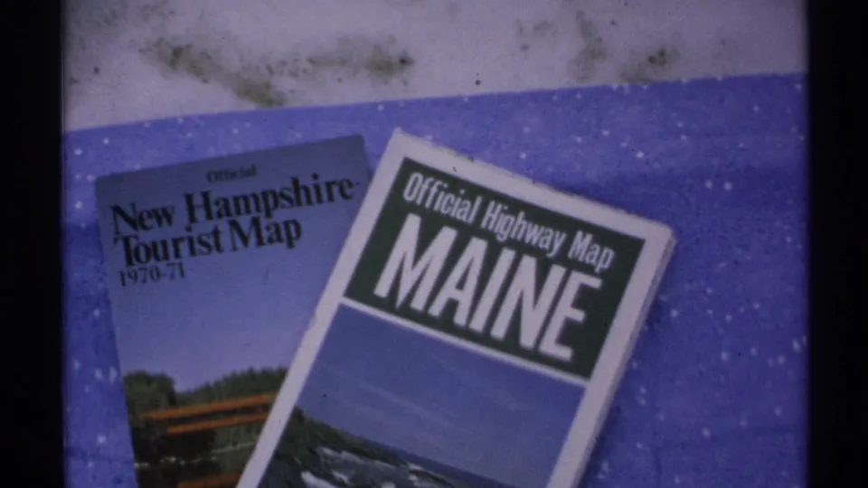 Early 1970s travel maps for New Hampshire and Maine laid out during a New England road-trip home movie.