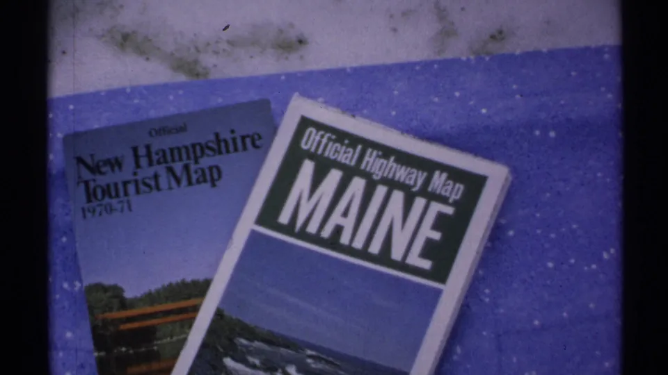 1971 home-movie cutaway showing New Hampshire and Maine travel maps used for a New England trip.