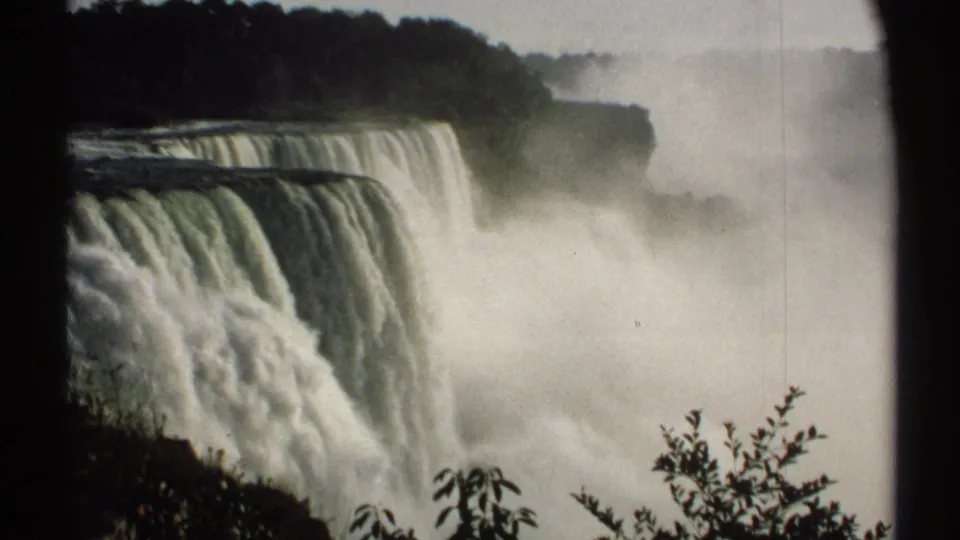 Close 1971 New York view of Niagara Falls, with wide curtains of water and mist softening the background cliffs.