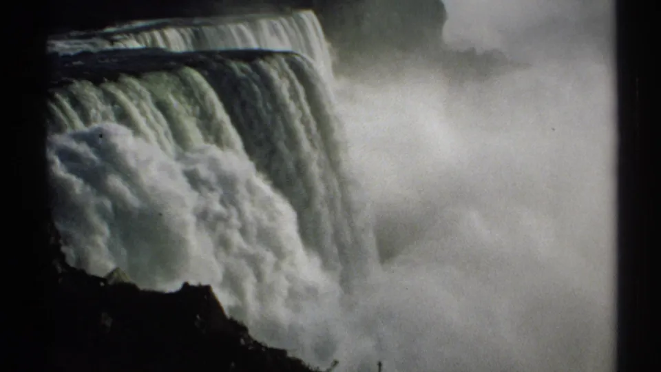 1971 8mm frame of Niagara Falls, with the falling water dominating the view and mist obscuring much of the lower gorge.