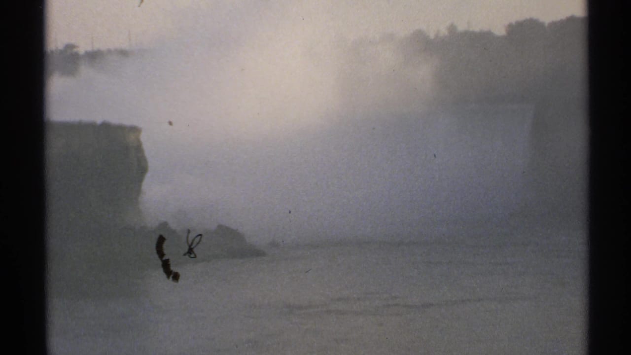 Misty water and cliff edge seen through an 8mm film frame.