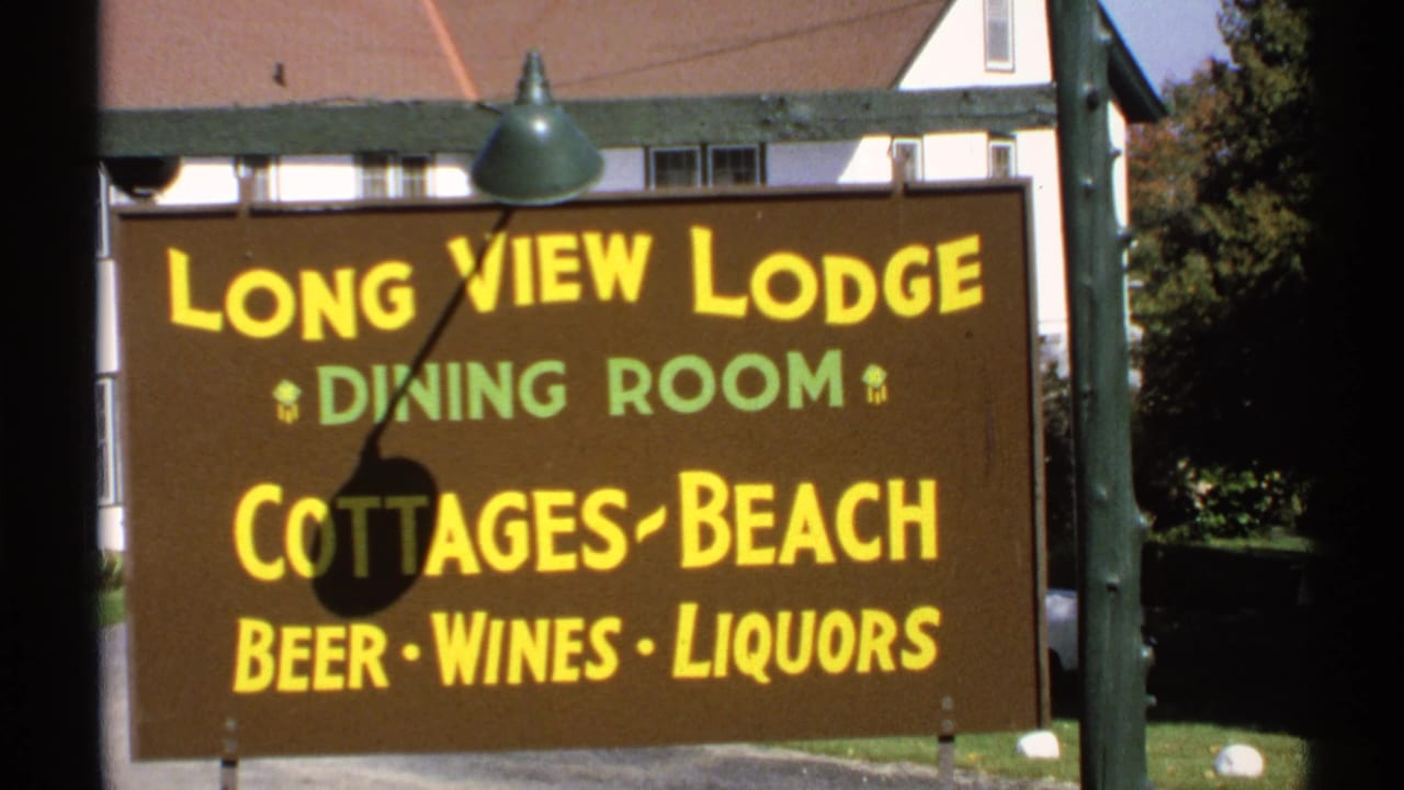 1971 New York 8mm frame showing a brown Long View Lodge sign beside part of a lodge building.