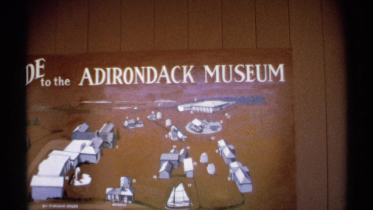 A vintage guide map for the Adirondack Museum shows a diagram of the grounds with buildings and a sailboat motif.