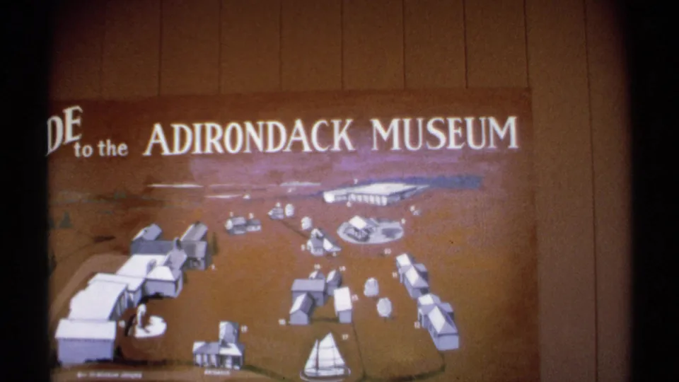 A vintage guide map for the Adirondack Museum shows a diagram of the grounds with buildings and a sailboat motif.