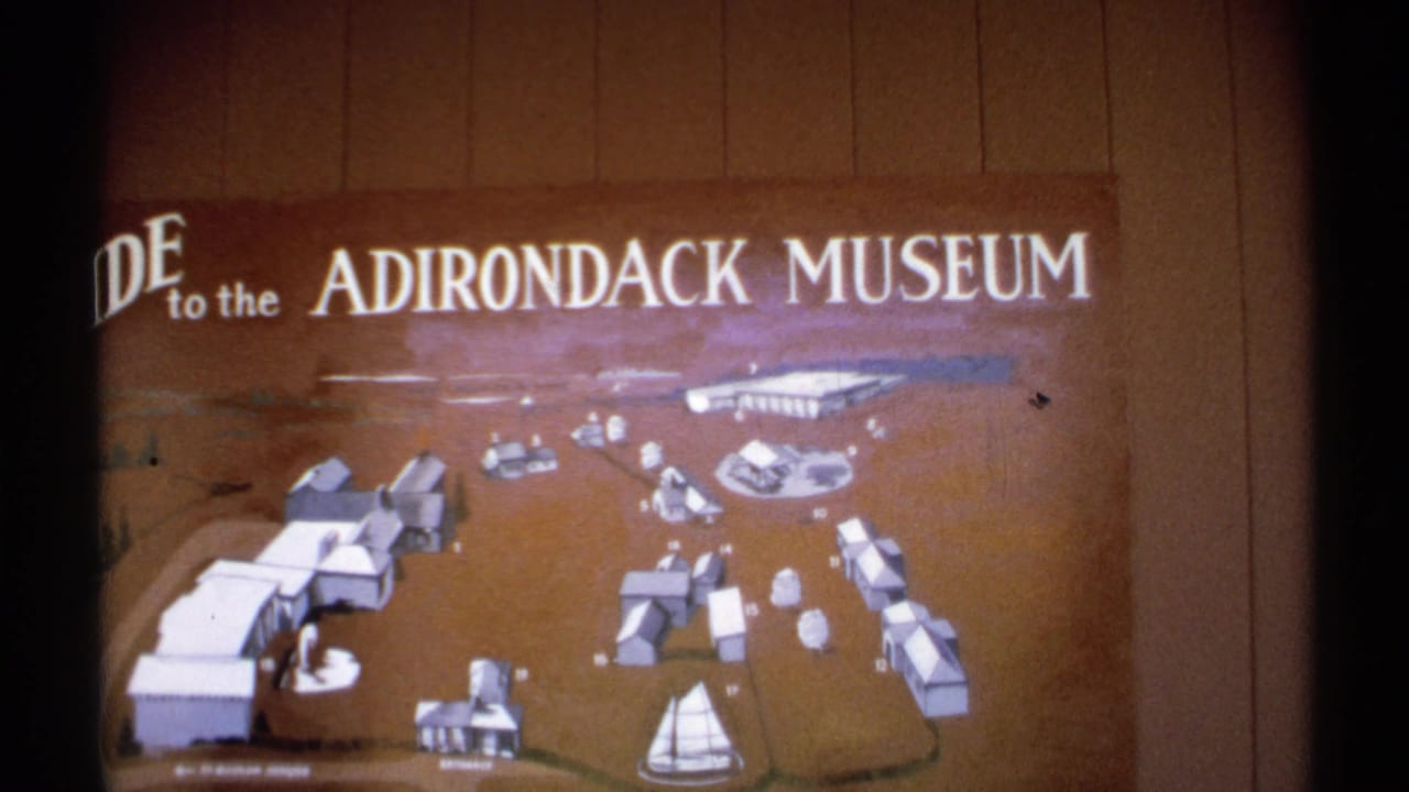 A final view of the Adirondack Museum guide map shows the museum title and illustrated grounds on a wood-paneled wall.