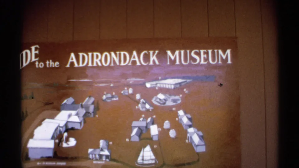 A final view of the Adirondack Museum guide map shows the museum title and illustrated grounds on a wood-paneled wall.
