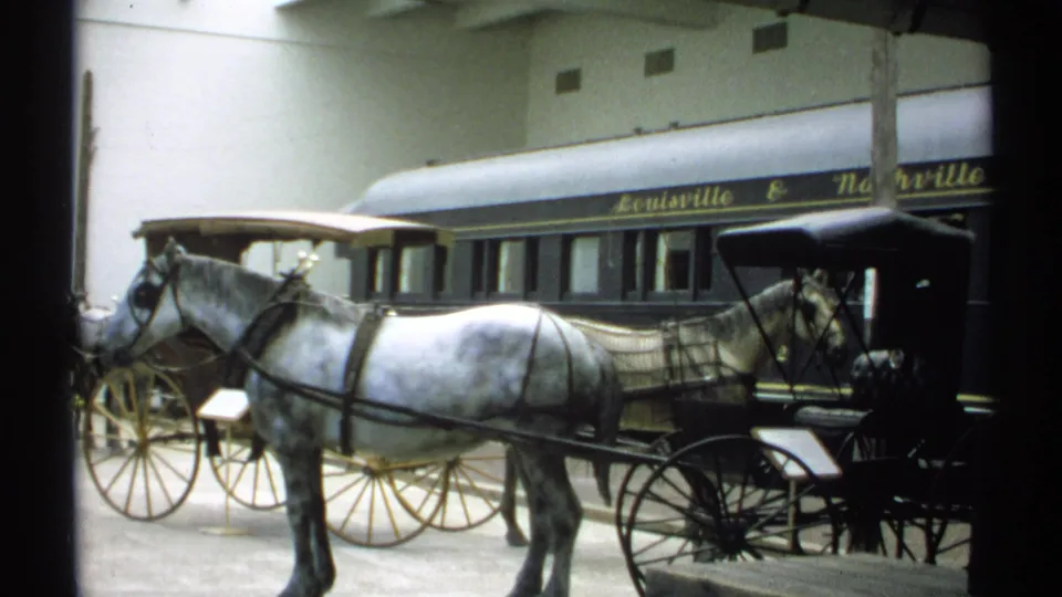 The closing 1971 frame holds on the white horse, black buggy, and Louisville & Nashville rail car inside the exhibit hall.