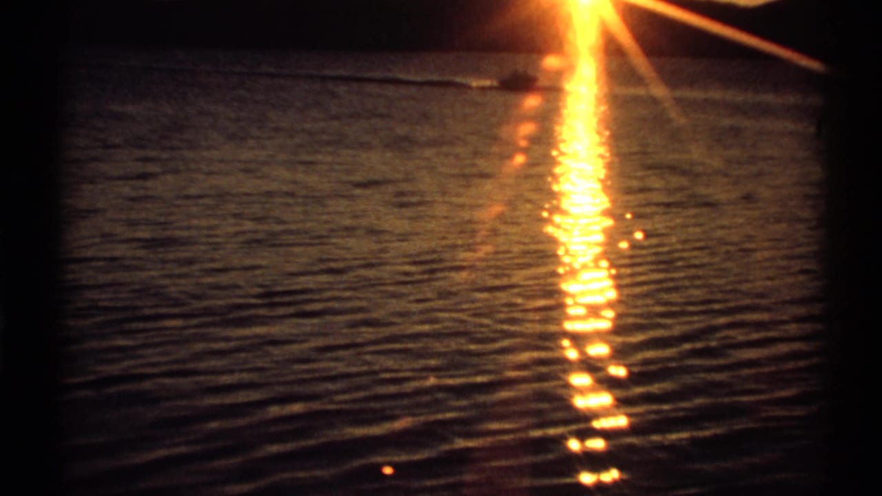 Bright sunset reflection stretching across rippling water.