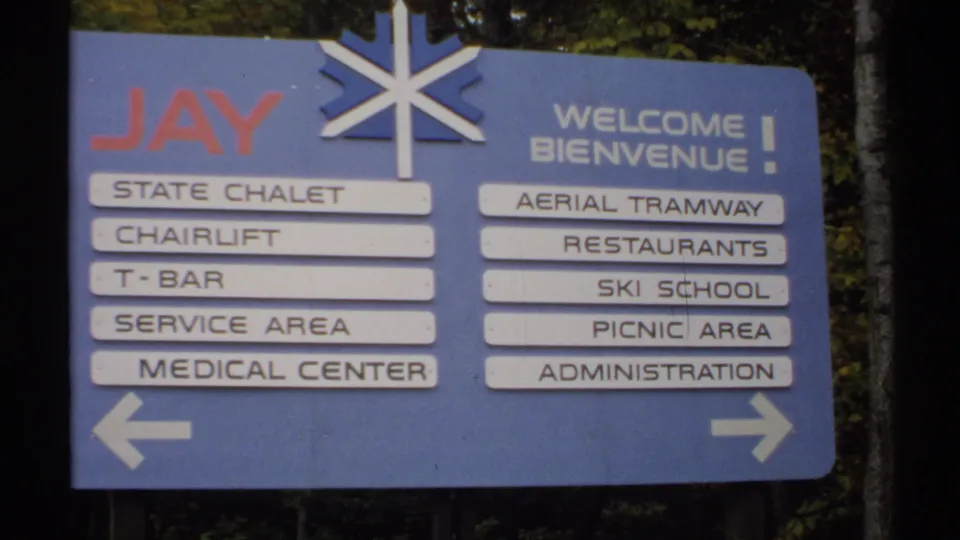1971 Vermont view of a Jay directional sign with English and French welcome text, arrows, and resort service listings.