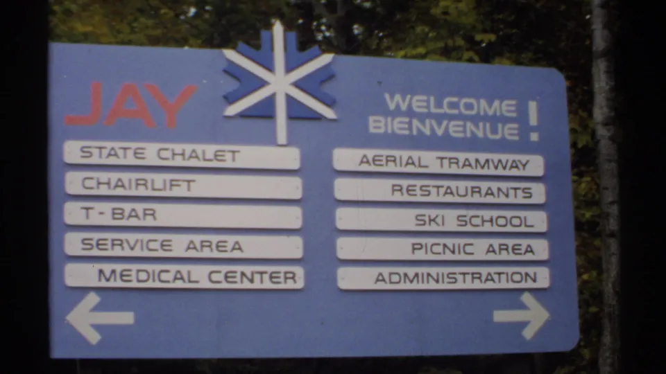 1971 Vermont frame showing the Jay welcome and directional sign with chairlift, ski school, restaurant, and administration labels.