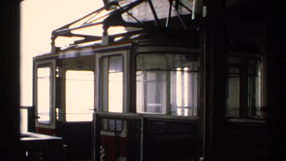 1971 Vermont 8mm frame showing an empty tram car or station car with broad windows, metal framing, and bright exterior light.