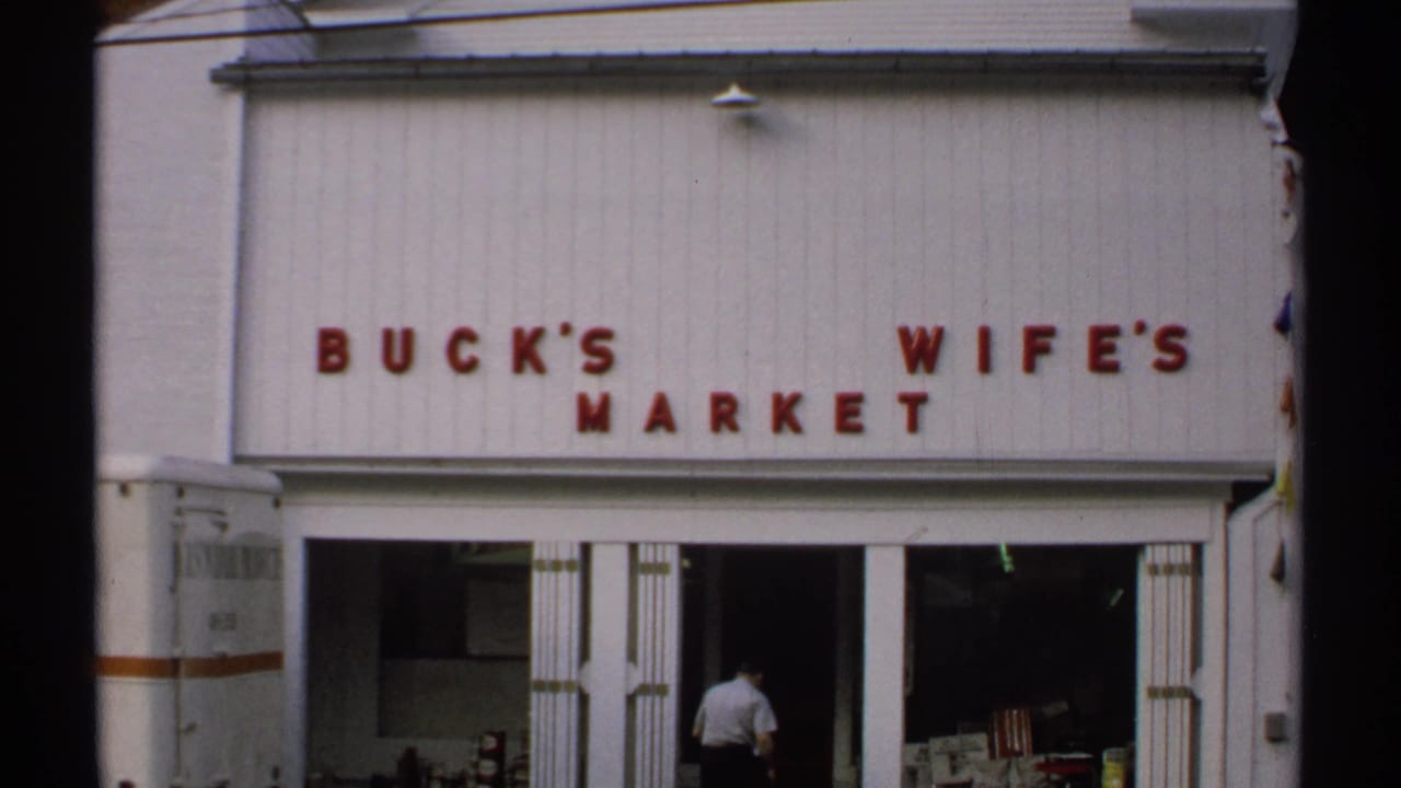 Buck's Wife's Market storefront with open doors and a man near the entrance.