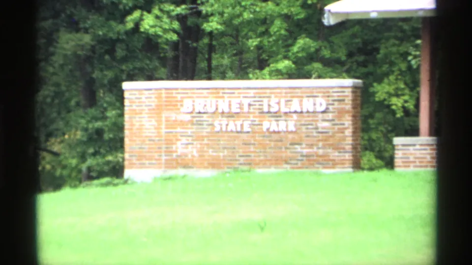Brick Brunet Island State Park sign in Wisconsin, filmed from a visitor's 8mm camera in 1971.