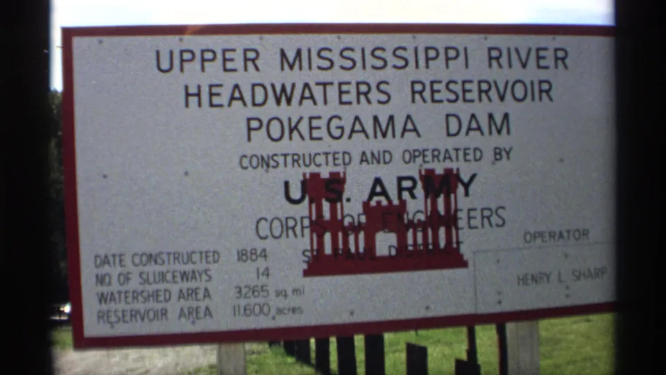 1971 Wisconsin 8mm frame with a close view of the Pokegama Dam reservoir sign and U.S. Army Corps of Engineers wording.