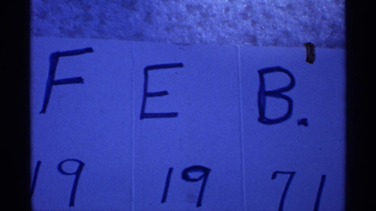 Handwritten FEB. 19 1971 date card in blue-tinted 8mm film.