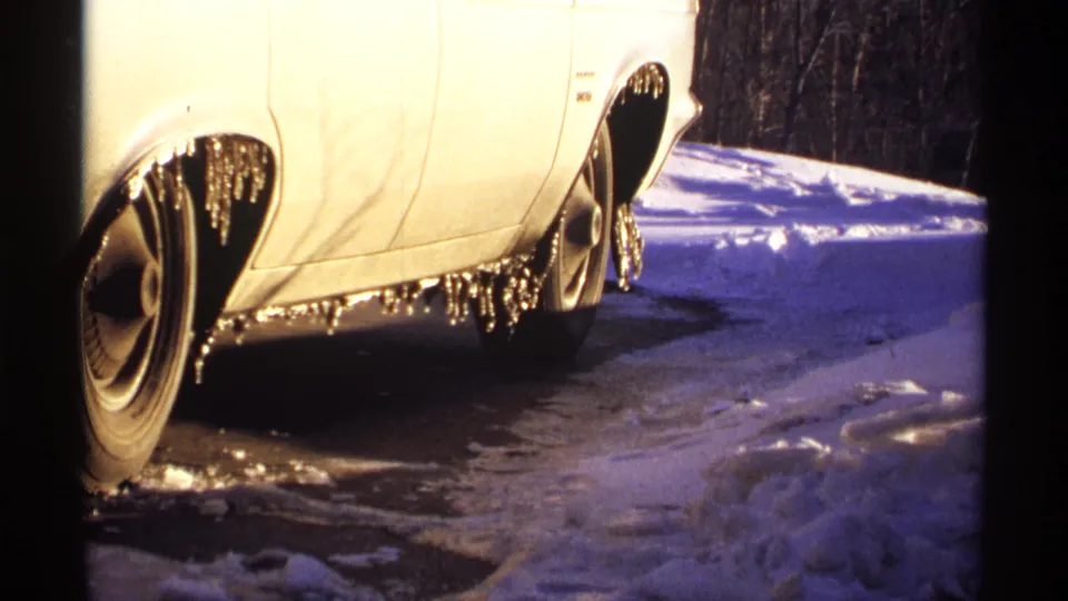 White car in snowy Wisconsin winter conditions, with icicles hanging from the wheels and lower body.