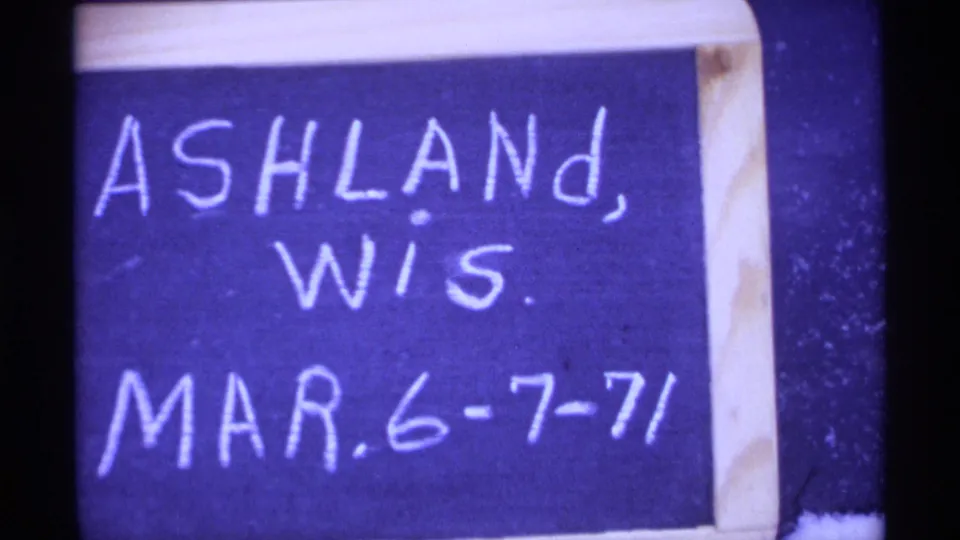 Handwritten board identifies Ashland, Wisconsin, with the date Mar. 6-7-71 in a 1971 8mm home-movie frame.