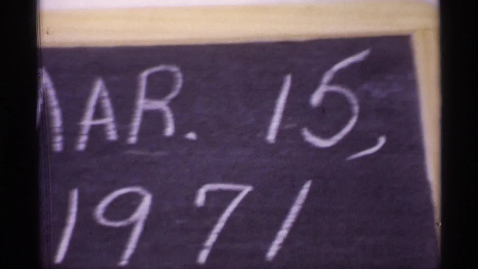 Close-up 8mm frame shows a chalkboard date reading Mar. 15, 1971, providing context for the reel.