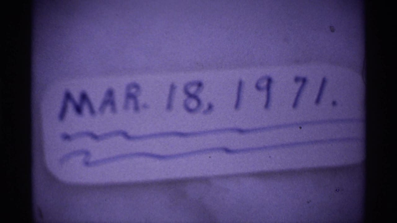 Handwritten date card for March 18, 1971, filmed in soft focus with visible 8mm grain and purple color shift.