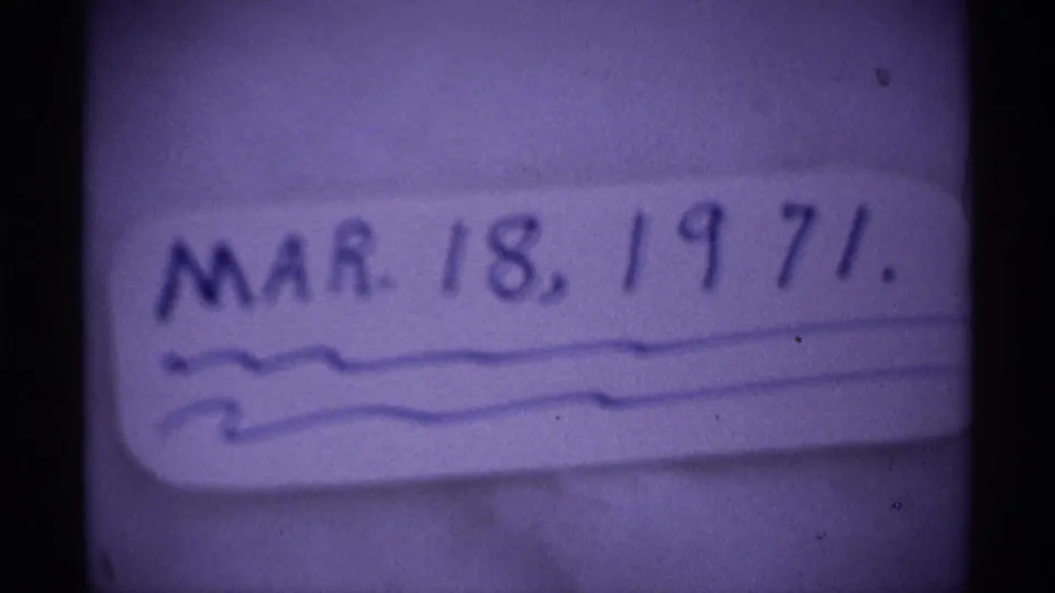 Handwritten date card for March 18, 1971, filmed in soft focus with visible 8mm grain and purple color shift.