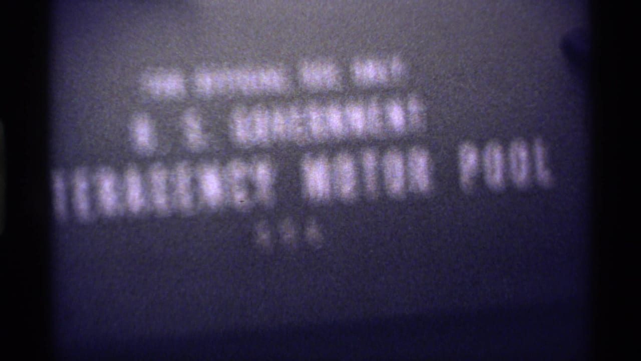 Blurred title card with U.S. Government Emergency Motor Pool text.