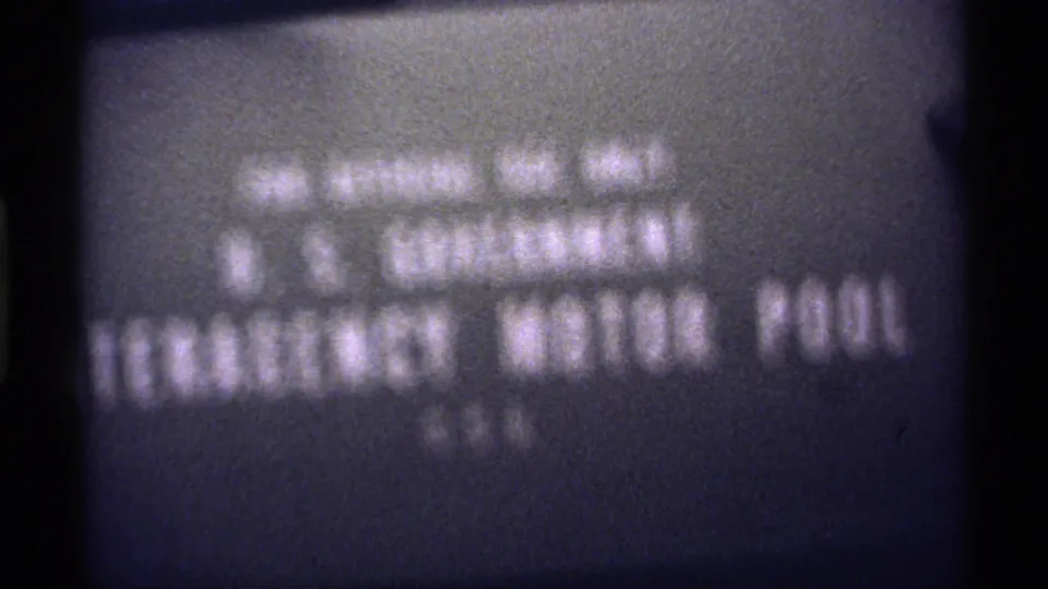 Final 1971 title-card frame showing soft U.S. Government Emergency Motor Pool text within a grainy, dark-edged film scan.