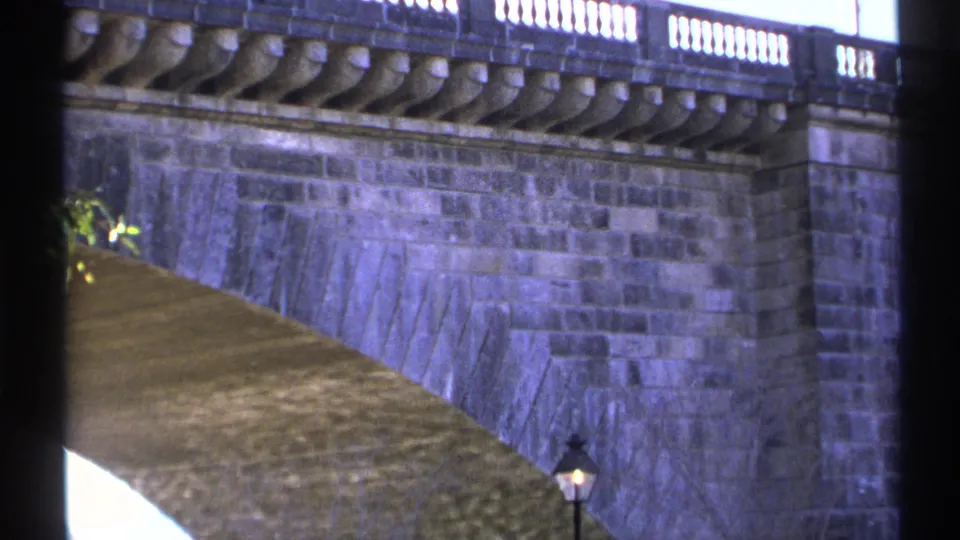 1972 Arizona 8mm view of a stone bridge or display wall with ornate balustrade and a vintage-style lamp post.