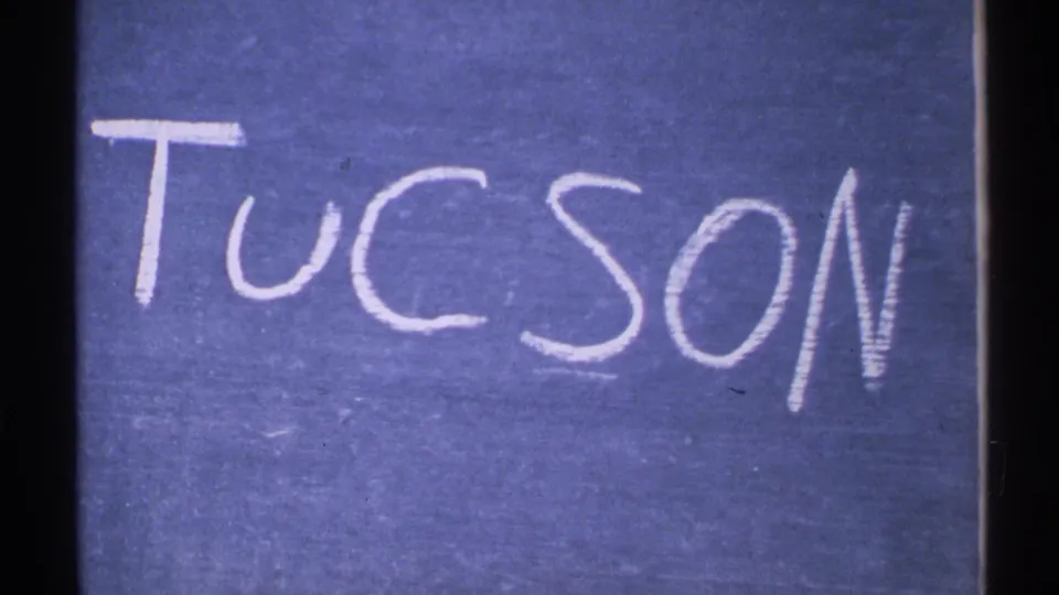Handwritten Tucson title card in white chalk on a blue background, from archival 8mm Arizona footage dated 1972.