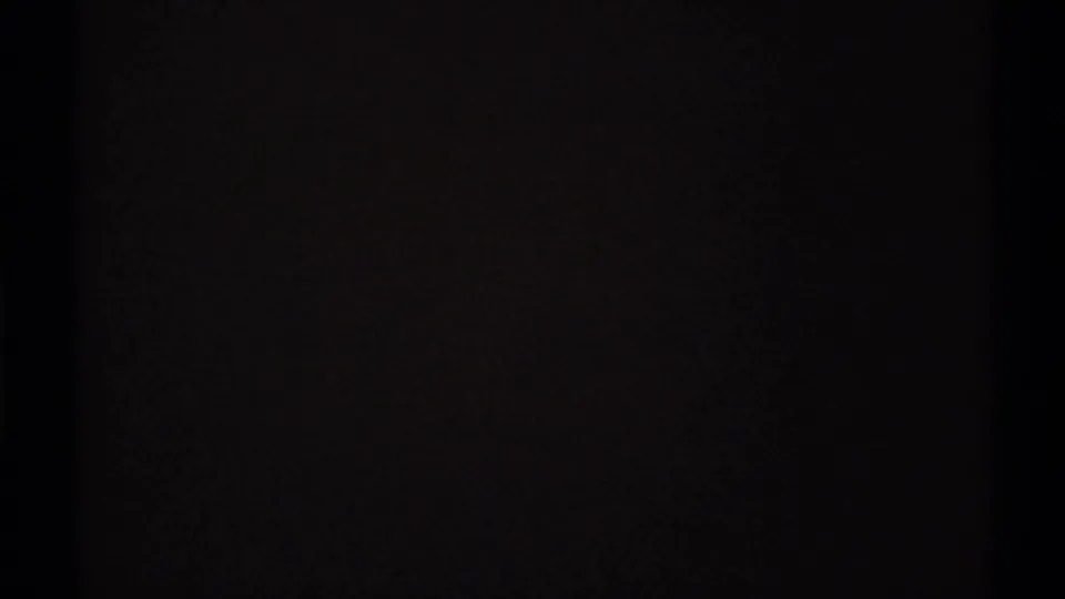 Dark final 8mm frame with minimal visible detail, likely from exposure change or the end of the shot.