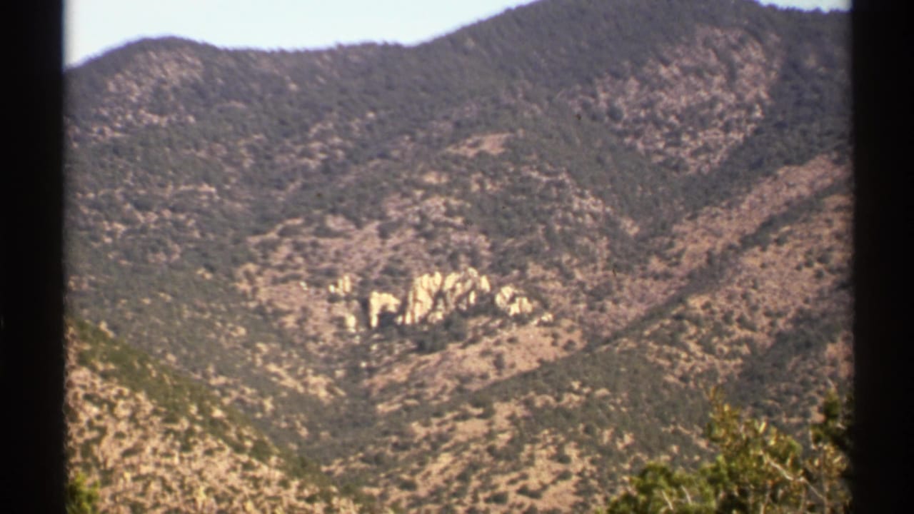 Distant rugged hills with pale rock formations and scrub vegetation.