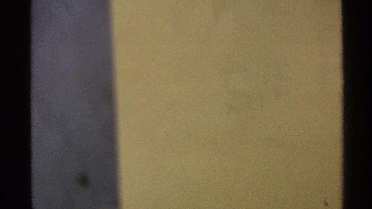 Blurred yellow wall or surface with dark vertical edge.