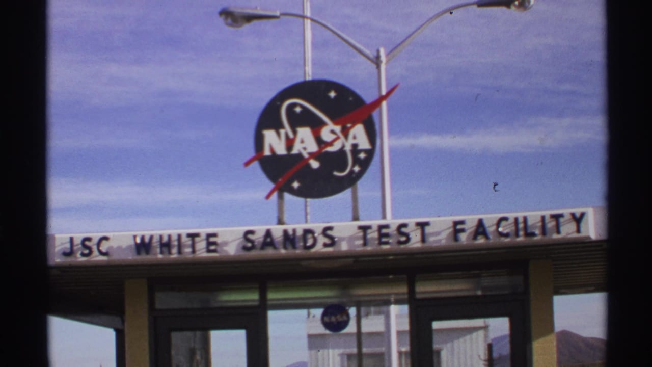NASA logo above JSC White Sands Test Facility sign and building entrance.