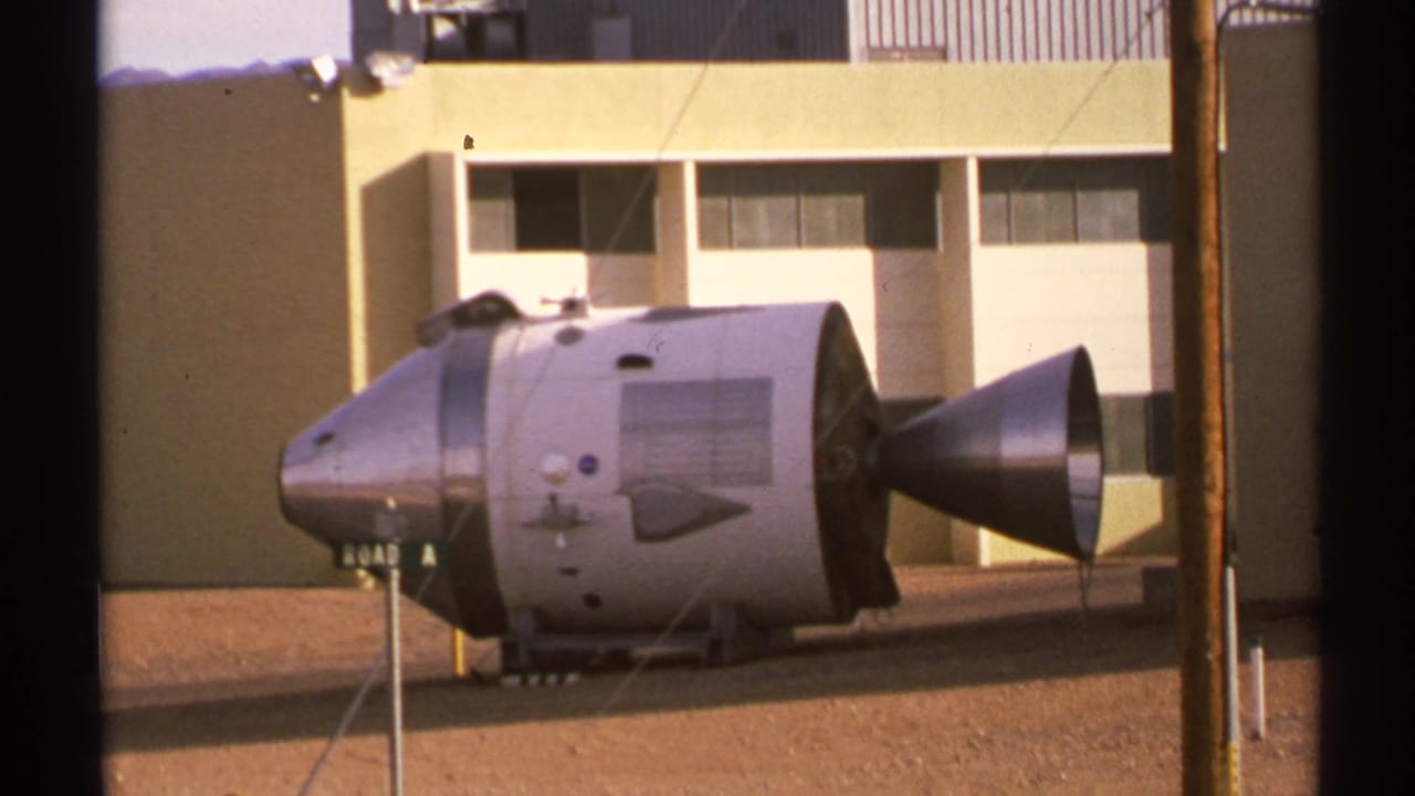 Apollo-style capsule display seen through dark vertical borders.
