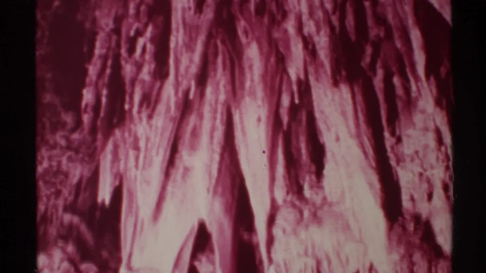 End frame from a 1972 New Mexico 8mm cave shot, showing soft-focus stalactites and shadowed rock textures.