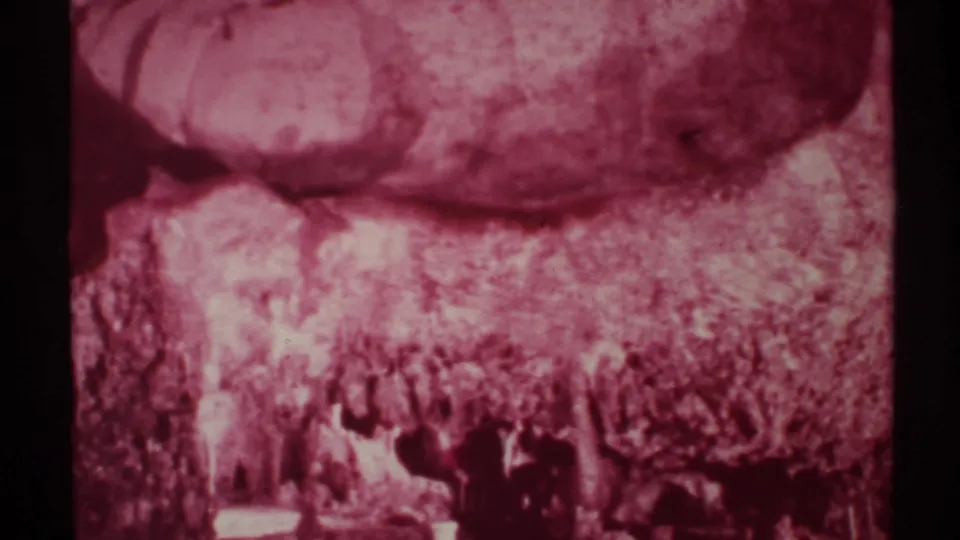Faded 8mm frame from New Mexico showing hikers crossing a rugged canyon floor in 1972.