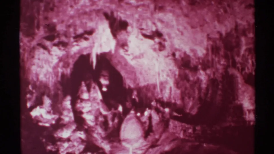 Close 8mm frame emphasizing the rough, cave-like stone texture and strong highlights in the New Mexico footage.