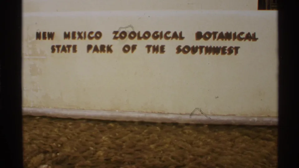 1972 New Mexico 8mm frame showing a painted sign for the New Mexico Zoological Botanical State Park of the Southwest.