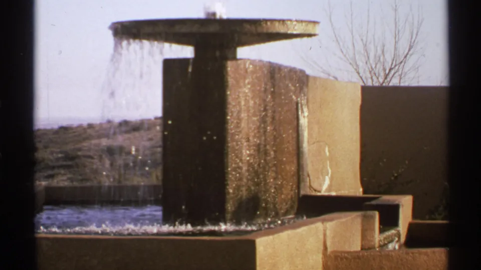 8mm frame from New Mexico in 1972 showing a cascading concrete fountain against a dry hillside.