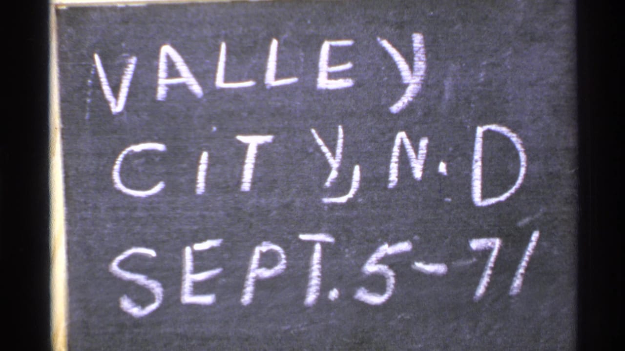 8mm home-movie frame showing the Valley City, N.D. chalk title card before the bridge scene.