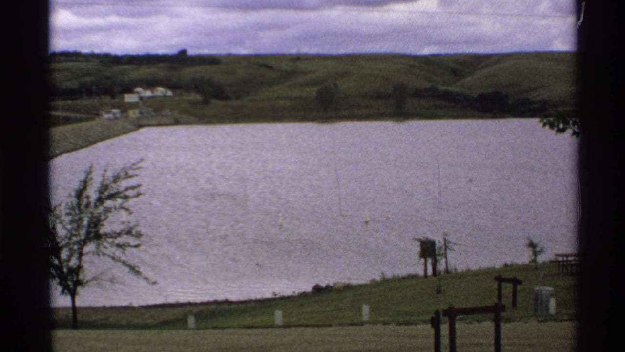 Lake Ashtabula Reservoir in North Dakota seen from a visitor viewpoint, with hills and shoreline features in soft 8mm color.